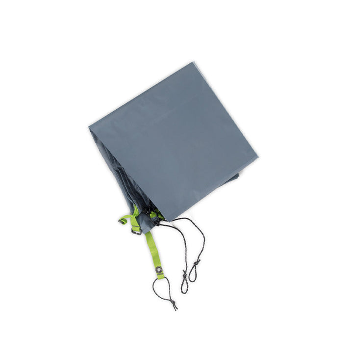 A folded NEMO Equipment Hornet OSMO™  Footprint, crafted from abrasion-resistant tarp with green straps and black cords attached, is shown on a white background.