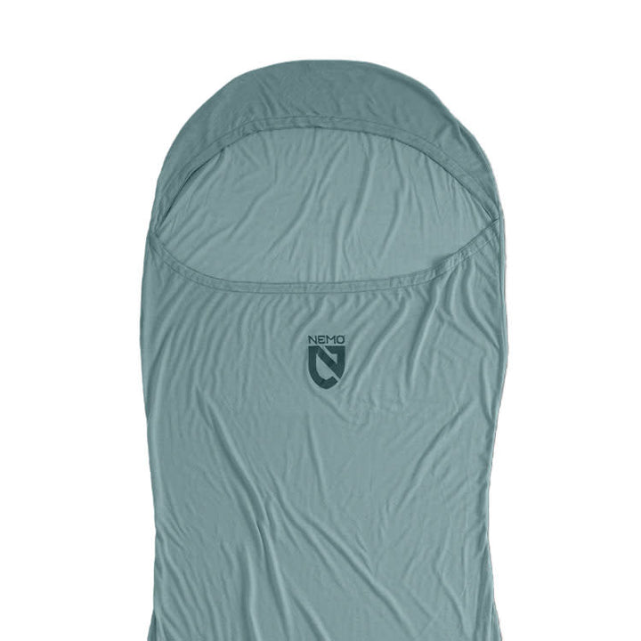 A light blue NEMO Equipment Tracer™ Endless Promise® Sleeping Bag Liner with hood, made from odor-resistant THERMOLITE EcoMade fabric, is displayed flat against a white background.